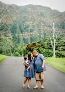 Family on road in front of ko'olau mountains